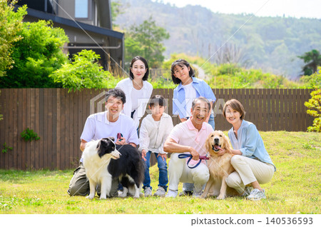 A family relaxing in the garden with their dog. A family relaxing in the garden with their dog. 140536593