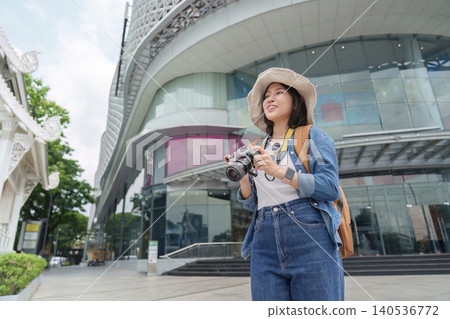 Asian woman tourist exploring modern city with camera for travel adventure 140536772