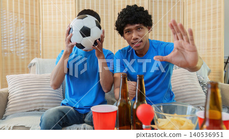 Asian and Southeast Asian men reacting with dismay to football game Asian and Southeast Asian men reacting with dismay to football game 140536951