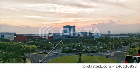 Dusk in a modern building area and a green roundabout Dusk in a modern building area and a green roundabout 140536958