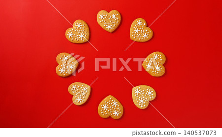 beautiful hand-baked cookies in the shape of a heart on a red background beautiful hand-baked cookies in the shape of a heart on a red background 140537073