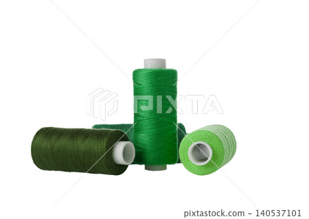 green spool of sewing thread isolated on white background green spool of sewing thread isolated on white background 140537101