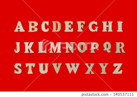 wooden letters of the English alphabet on a red background 140537111