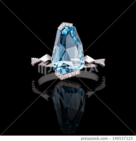 Beautiful white gold ring with diamonds and aquamarine on a black background Beautiful white gold ring with diamonds and aquamarine on a black background 140537123