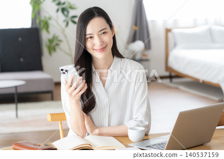 A woman doing telework in the living room A woman doing telework in the living room 140537159