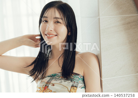 A woman wearing a scarf around her body as part of her fashion. A woman wearing a scarf around her body as part of her fashion. 140537258