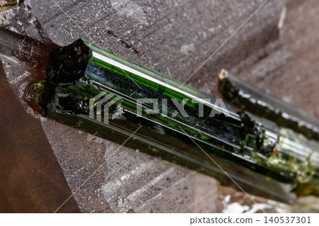 Macro mineral tourmaline stone in quartz on a white background 140537301