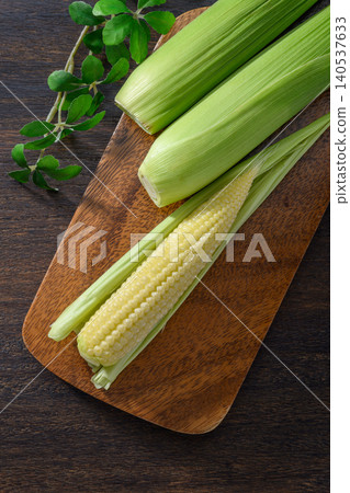 Fresh baby corn and a wooden cutting board Fresh baby corn and a wooden cutting board 140537633