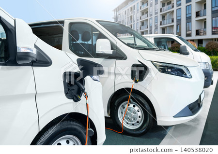 Close up of electric delivery van with connected charging cable Close up of electric delivery van with connected charging cable 140538020