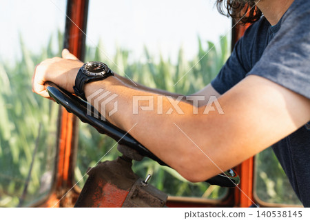 Man drives a tractor. Hand's close up Man drives a tractor. Hand's close up 140538145
