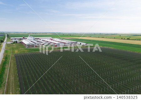 Modern poultry farm with solar panels. Factory using renewable energy. Aerial view. Modern poultry farm with solar panels. Factory using renewable energy. Aerial view. 140538325