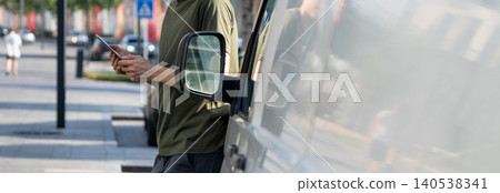 Manager with a digital tablet next to delivery van. Fleet management. Manager with a digital tablet next to delivery van. Fleet management. 140538341