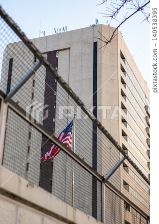 An American flag behind a security fence An American flag behind a security fence 140538395