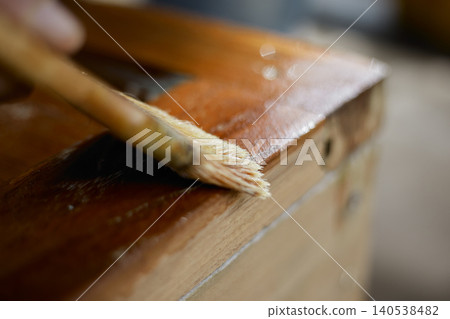 hand applying stain on wood hand applying stain on wood 140538482