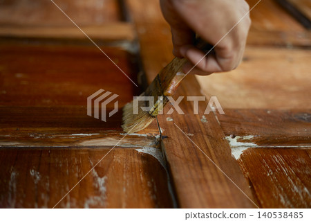 hand applying stain on wood hand applying stain on wood 140538485