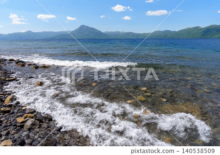 Lake Shikotsu and Mount Eniwa: A breathtaking Hokkaido landscape with crystal-clear waters. Lake Shikotsu and Mount Eniwa: A breathtaking Hokkaido landscape with crystal-clear waters. 140538509