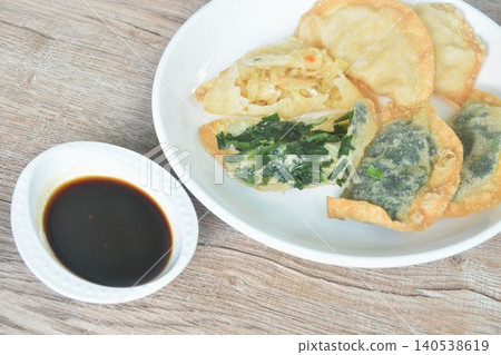 deep fried Guizhou of dumpling stuffed slice garlic chive and chop cabbage on plate dipping spicy black soy sauce deep fried Guizhou of dumpling stuffed slice garlic chive and chop cabbage on plate dipping spicy black soy sauce 140538619