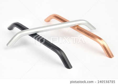 Metal handles in three colors placed in a crossed position on a white background Metal handles in three colors placed in a crossed position on a white background 140538785