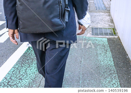 An elderly businessman wearing an arm mask in the urban landscape of Yokohama, Japan... A scene of commuting on a hot and humid morning... Still unable to let go of his mask = Yokohama City 140539196