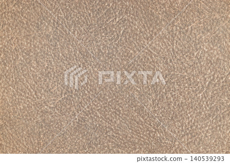 A light brown textured leather surface showing fine natural grain details A light brown textured leather surface showing fine natural grain details 140539293