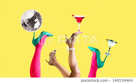 Disco party legs holding cocktails and mirror ball on bright yellow background. 140539464
