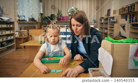 Shape sorting lesson with preschool girl developing focus and problem solving skills 140540355