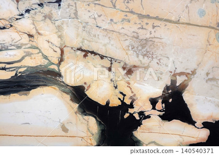 View of marble stone with lines and patterns in different shades in a natural setting View of marble stone with lines and patterns in different shades in a natural setting 140540371