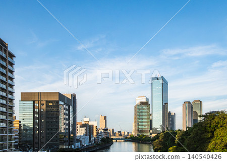 The cityscape of skyscrapers reflected in the river against the twilight sky. The cityscape of skyscrapers reflected in the river against the twilight sky. 140540426