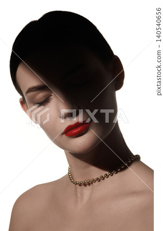 Close beauty portrait of woman with red lips and soft shadow over closed eyes on white background. 140540656