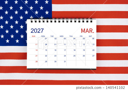 March 2027 desk calendar on United States of America flag. March 2027 desk calendar on United States of America flag. 140541102