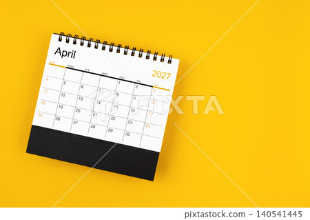 April 2027 desk calendar on yellow background, position with copy space. April 2027 desk calendar on yellow background, position with copy space. 140541445