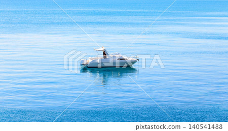 A peaceful scene of a boat drifting on calm waters, capturing the essence of solitude and nature's beauty A peaceful scene of a boat drifting on calm waters, capturing the essence of solitude and nature's beauty 140541488