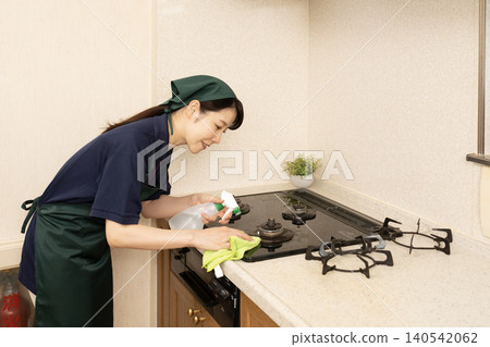 House cleaning woman cleaning the gas range 140542062