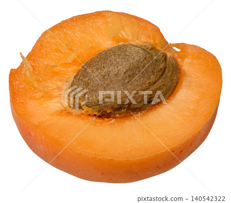 Juicy half of a ripe orange apricot with a large brown pit inside 140542322
