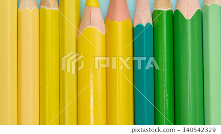 Close-up of a row of green and yellow wooden pencils Close-up of a row of green and yellow wooden pencils 140542329