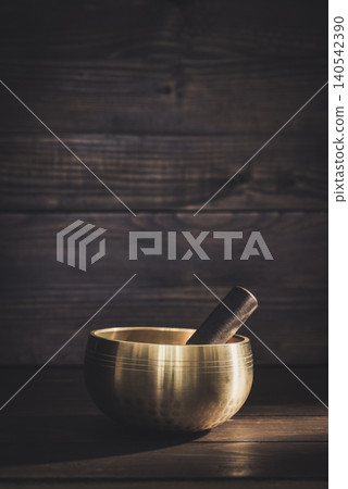 A calming wellness scene featuring a singing bowl A calming wellness scene featuring a singing bowl 140542390