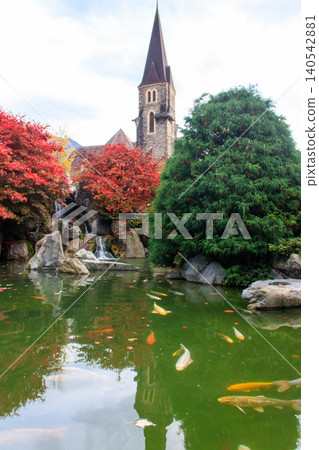Catholic Church of St. Joseph and artificial pond with fish at autumn in Interlaken, Switzerland Catholic Church of St. Joseph and artificial pond with fish at autumn in Interlaken, Switzerland 140542881