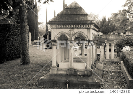Stone crosses and tombstones in a cemetery. Black and white toned Stone crosses and tombstones in a cemetery. Black and white toned 140542888