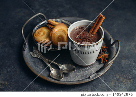 Traditional Mexican champurrado hot drink in a cup with cookies, cinnamon stick, and star anise Traditional Mexican champurrado hot drink in a cup with cookies, cinnamon stick, and star anise 140542976