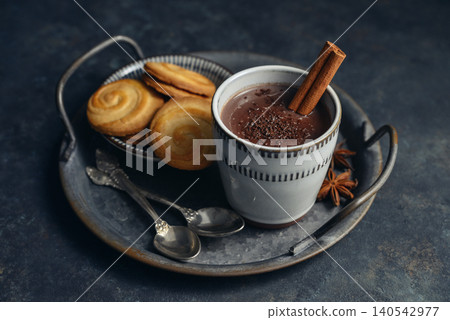 Traditional Mexican champurrado hot drink in a cup with cookies, cinnamon stick, and star anise Traditional Mexican champurrado hot drink in a cup with cookies, cinnamon stick, and star anise 140542977