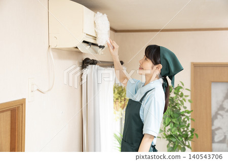 Female worker cleaning the house to clean the air conditioner Female worker cleaning the house to clean the air conditioner 140543706