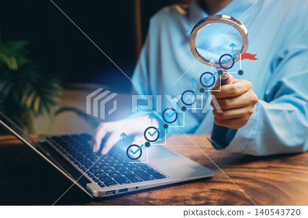 Business Professional Analyzing Data Trends with Magnifying Glass Over Laptop in Modern Office Setting Business Professional Analyzing Data Trends with Magnifying Glass Over Laptop in Modern Office Setting 140543720