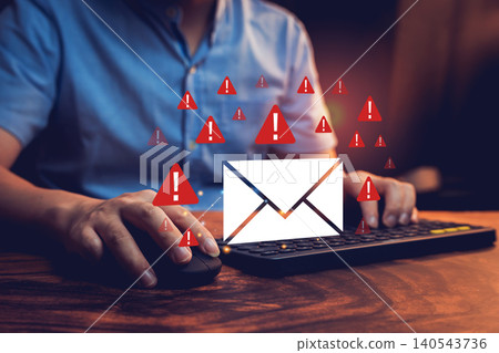 Email concept. Young businessman typing on keyboard with warning alerts around a digital envelope symbolizing cybersecurity threats 140543736