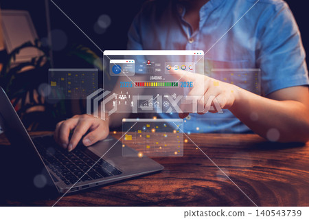 Goal 2025 concept. Businessman Using Laptop to Manage Data with Virtual Interfaces and Graphic Charts in a Dark Workspace Goal 2025 concept. Businessman Using Laptop to Manage Data with Virtual Interfaces and Graphic Charts in a Dark Workspace 140543739