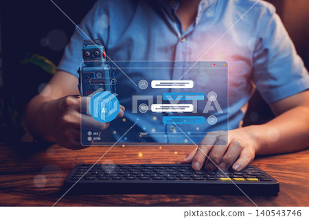 Businessman using AI chatbot technology on computer screen with robotic toy in hand in modern office environment Businessman using AI chatbot technology on computer screen with robotic toy in hand in modern office environment 140543746