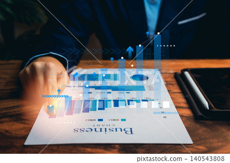 Business Professional Analyzing Growth Trends on a Digital Chart with Overlay Graphs and Data Analytics Visualizations 140543808