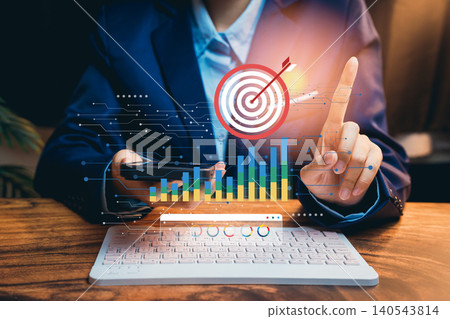 Business Professional Using Smartphone with Chart and Target Graphic for Goal Setting and Data Analysis in Office Environment Business Professional Using Smartphone with Chart and Target Graphic for Goal Setting and Data Analysis in Office Environment 140543814
