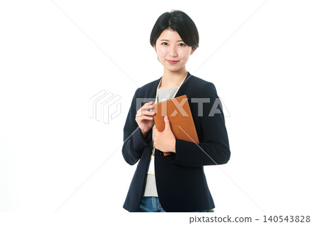 A young woman in a jacket, facing forward, holding a binder. A young woman in a jacket, facing forward, holding a binder. 140543828