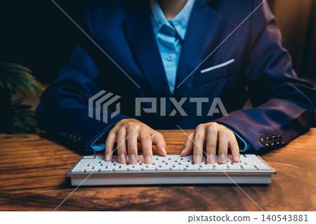 Professional Businessman in Suit Typing on Keyboard in Modern Office Setting with Warm Lighting Professional Businessman in Suit Typing on Keyboard in Modern Office Setting with Warm Lighting 140543881