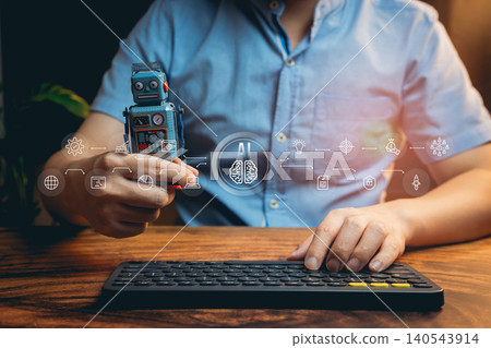 Ai concept. Creative Individual Holding Vintage Robot Toy While Working on Keyboard with AI Technology Concepts in Background 140543914